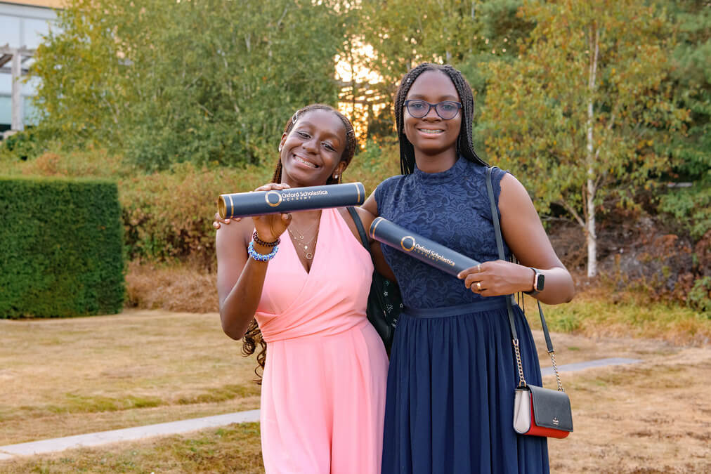 Two Oxford Scholastica Academy students celebrating with their certificates