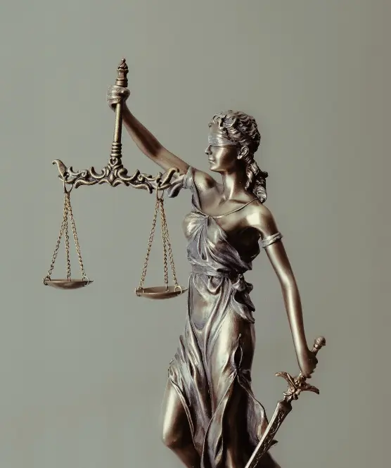 Statue of a figure holding up scales