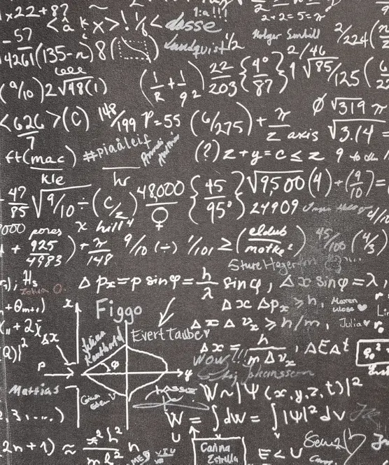 Maths equations and work written on a chalkboard