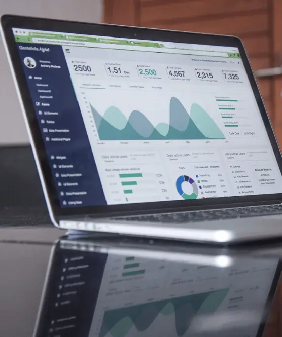 Open laptop showing business graphs and statistics