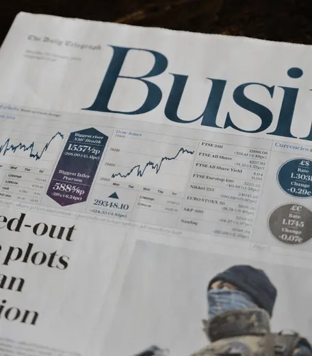 Business newspaper showing financial information