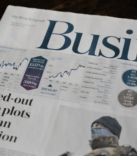 Front page of a newspaper with business graphs and statistics