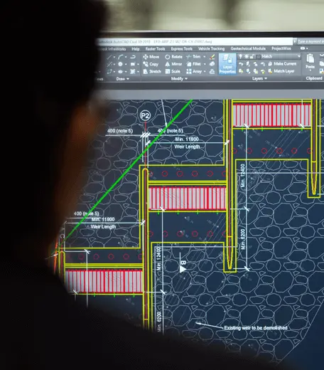 student sat in front of a computer looking at a tech diagram