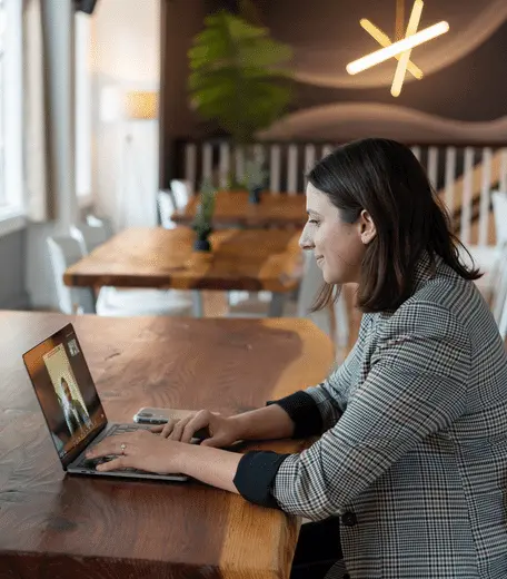 woman sat at her laptop, on a video call