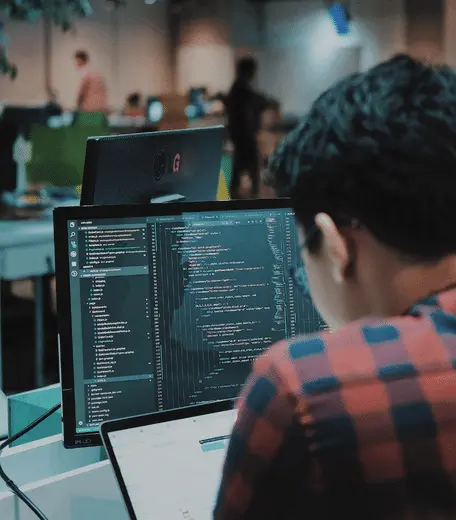 student sat at a computer doing some coding