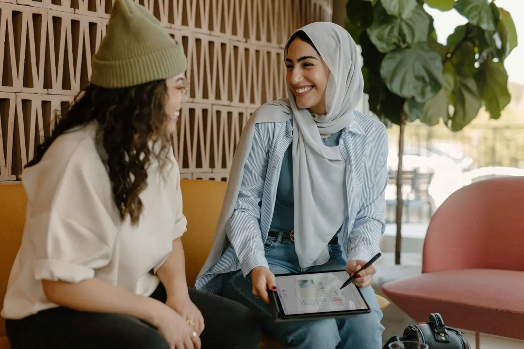 Two people sitting across from each other, talking