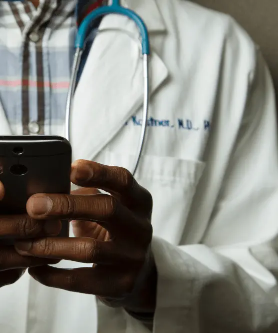 Torso of a doctor using his phone