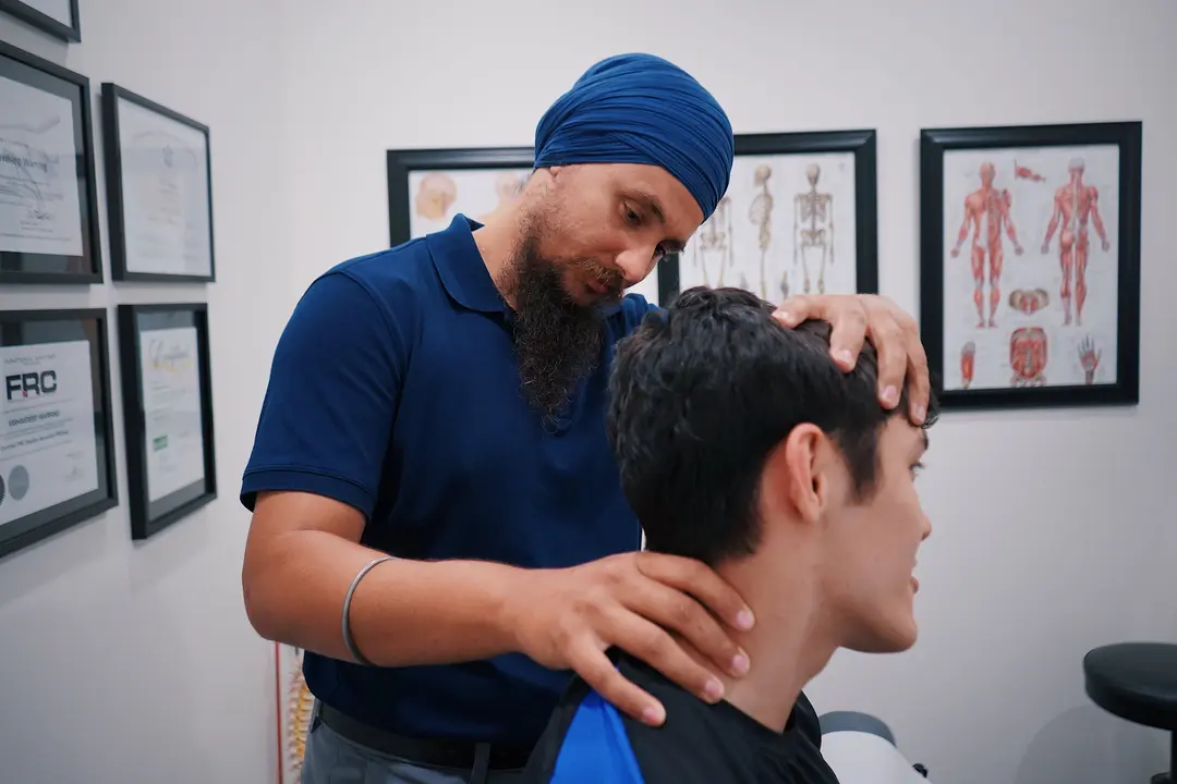 Physiotherapist examining patient's neck