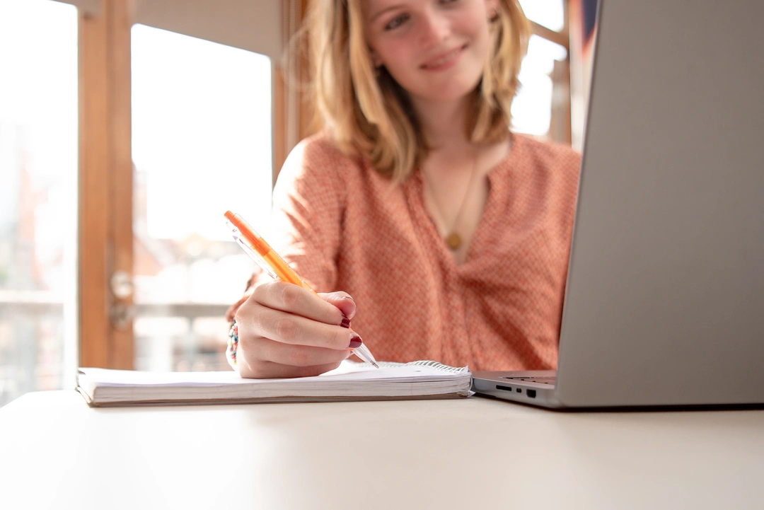 OxBright Psychology student writing in notebook