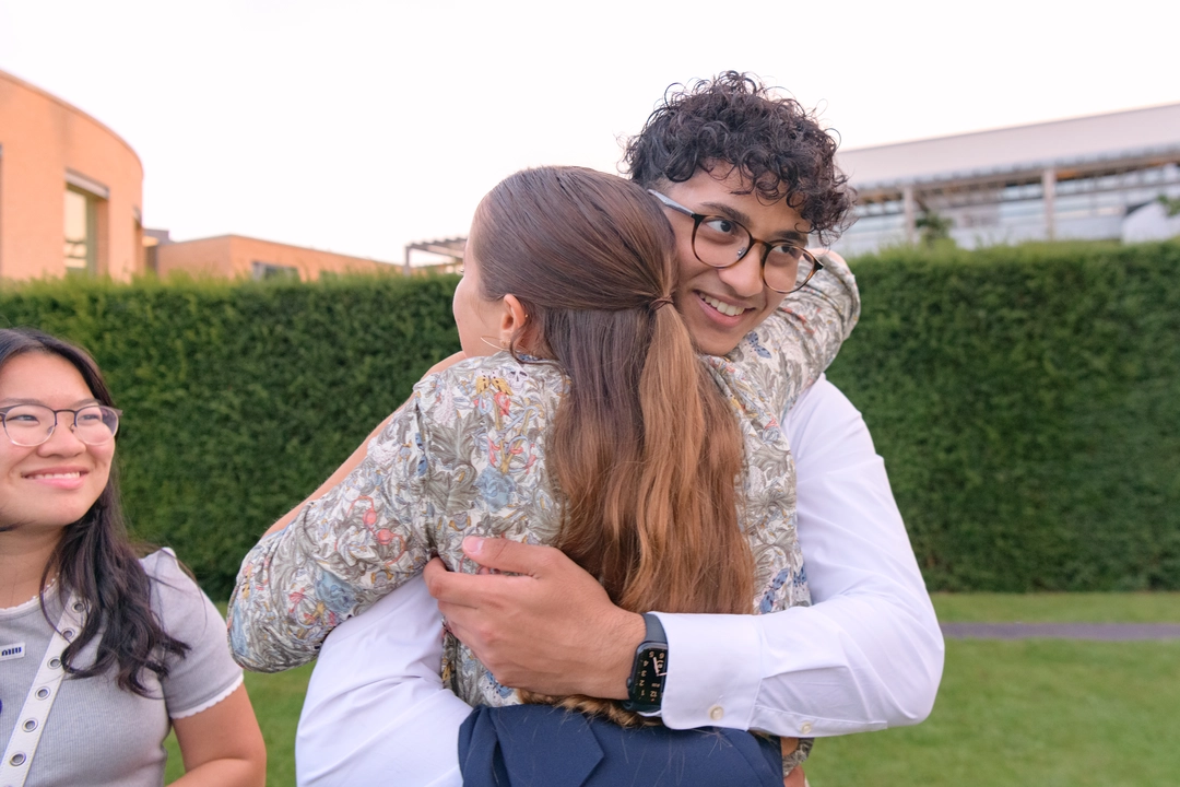 Two students hugging