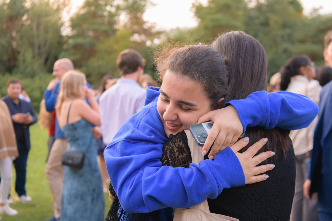 Two students hugging